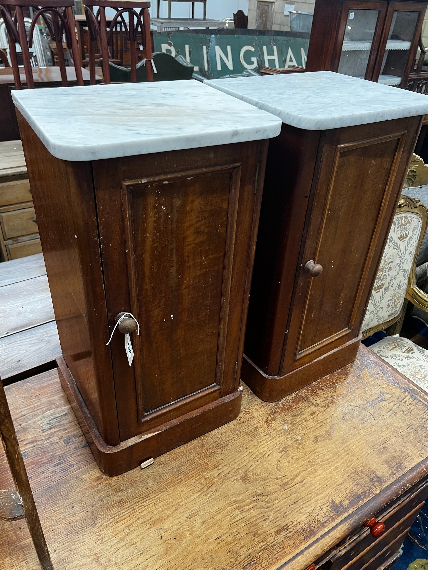 A near pair of Victorian mahogany marble topped bedside cabinets, width 38cm depth 36cm height 74cm